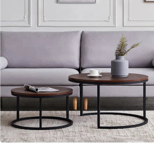 Oblivis Nesting Coffee Table set with black metal frames and walnut-finish tops in modern living room setting