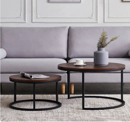 Oblivis Nesting Coffee Table set with black metal frames and walnut-finish tops in modern living room setting